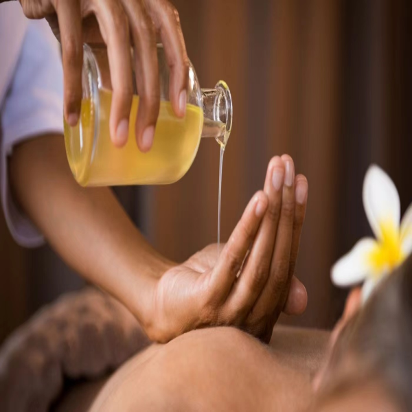 A massage therapist preparing aromatherapy oil for a wellness treatment